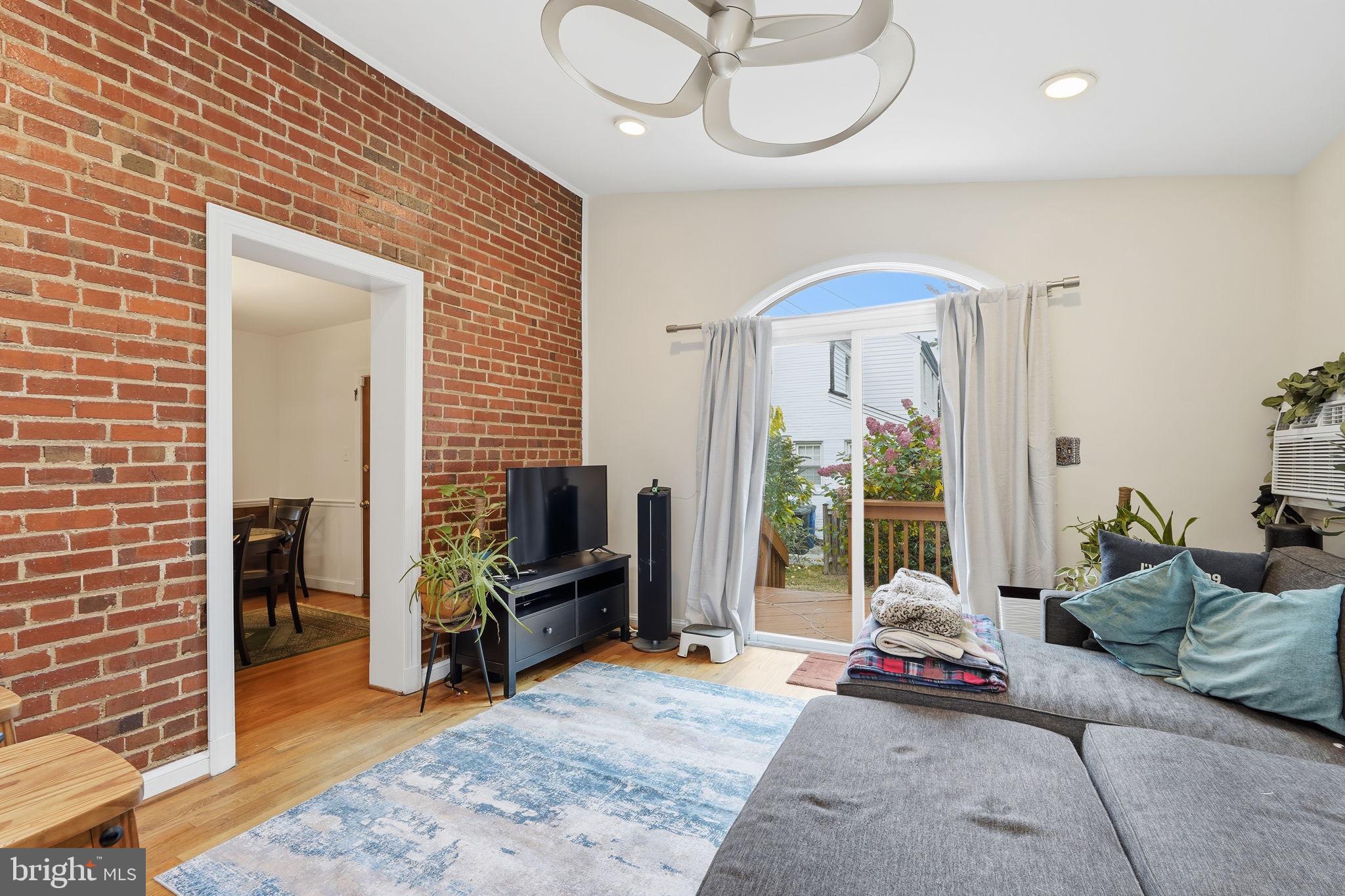 8209 Meadowbrook Lane Chevy Chase, MD 20815 - Photo 7 of 24 a living room with furniture and a flat screen tv