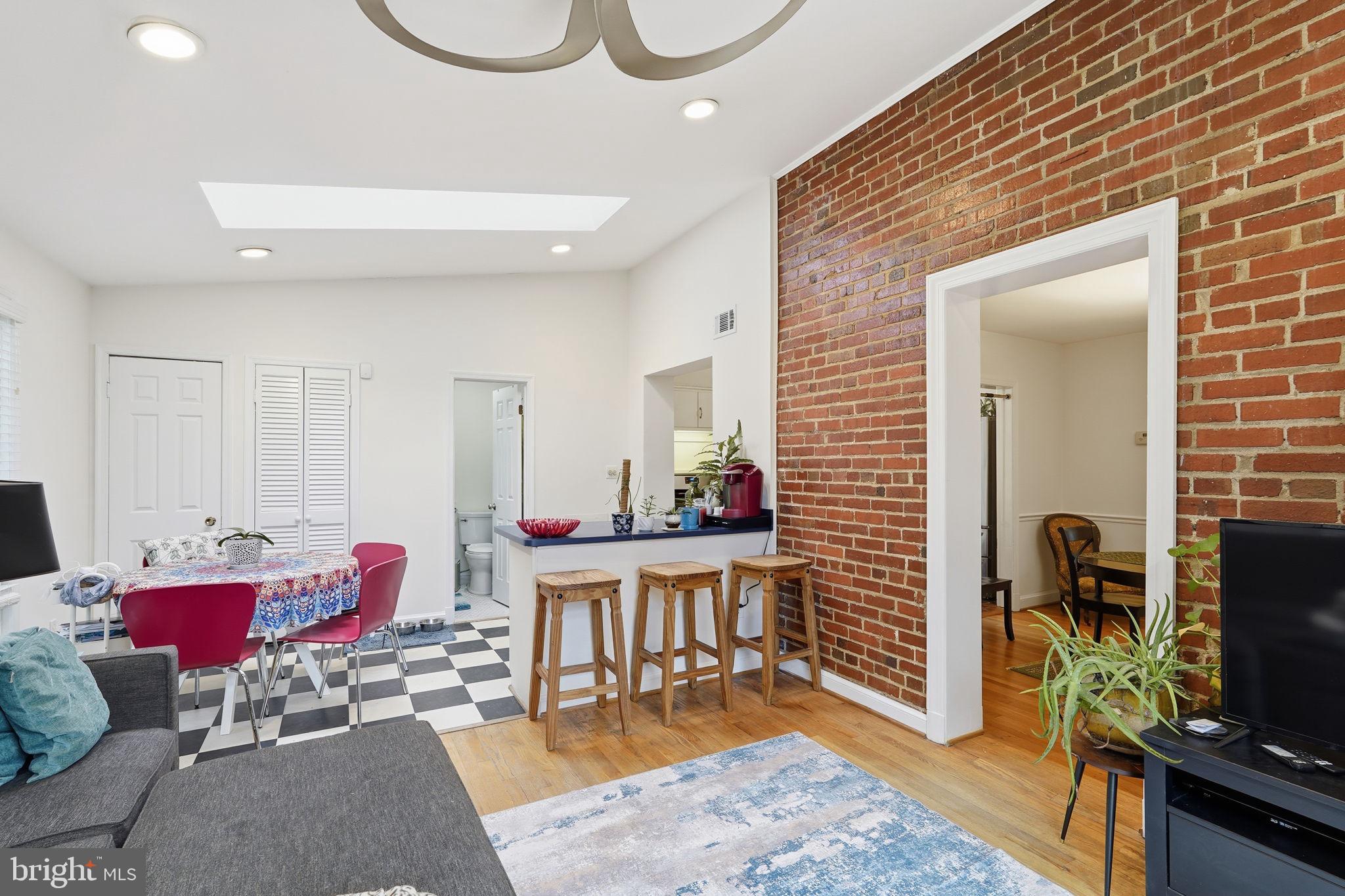 8209 Meadowbrook Lane Chevy Chase, MD 20815 - Photo 8 of 24 a living room with furniture a rug and a flat screen tv