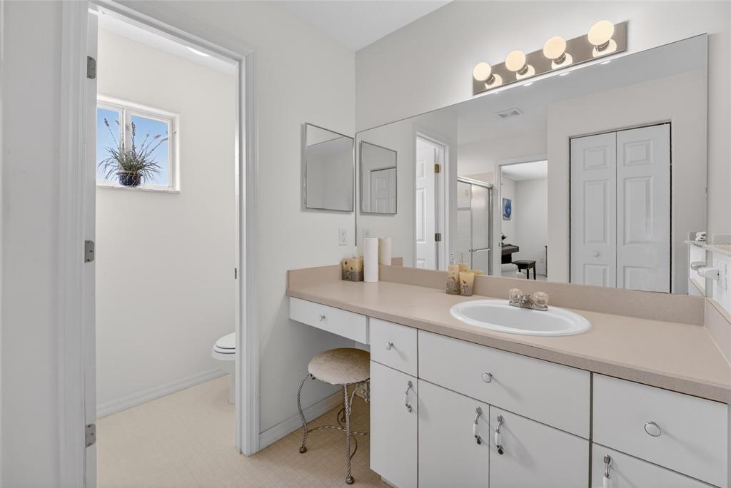 6032 Southwest 103rd Loop Ocala, FL 34476 - Photo 13 of 28 a bathroom with a sink a toilet a mirror and shower