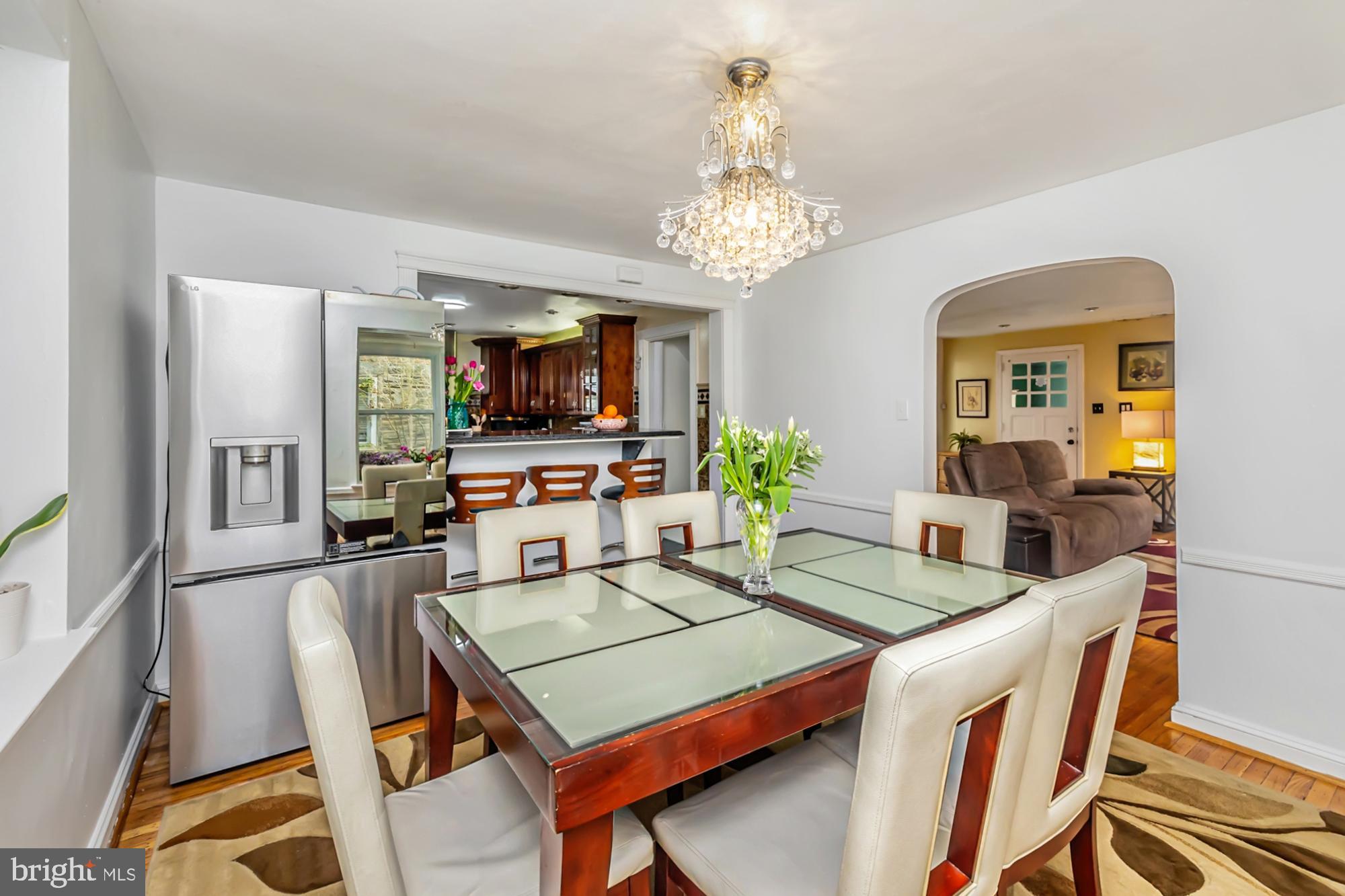 320 Prospect Road Springfield, PA 19064 - Photo 13 of 78 a view of a dining room with furniture a chandelier and wooden floor