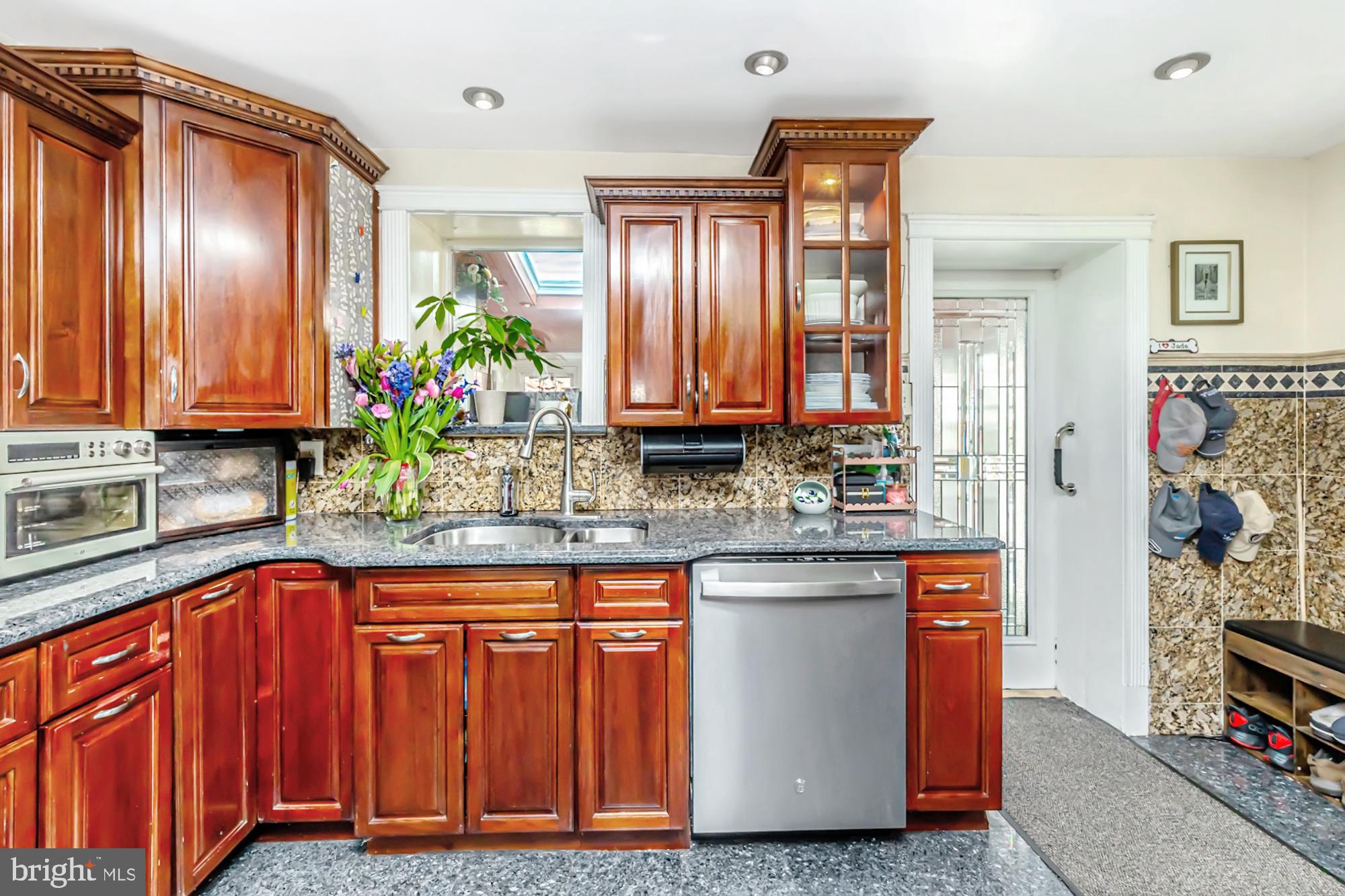 320 Prospect Road Springfield, PA 19064 - Photo 17 of 78 a kitchen with stainless steel appliances granite countertop wooden cabinets and a granite counter tops