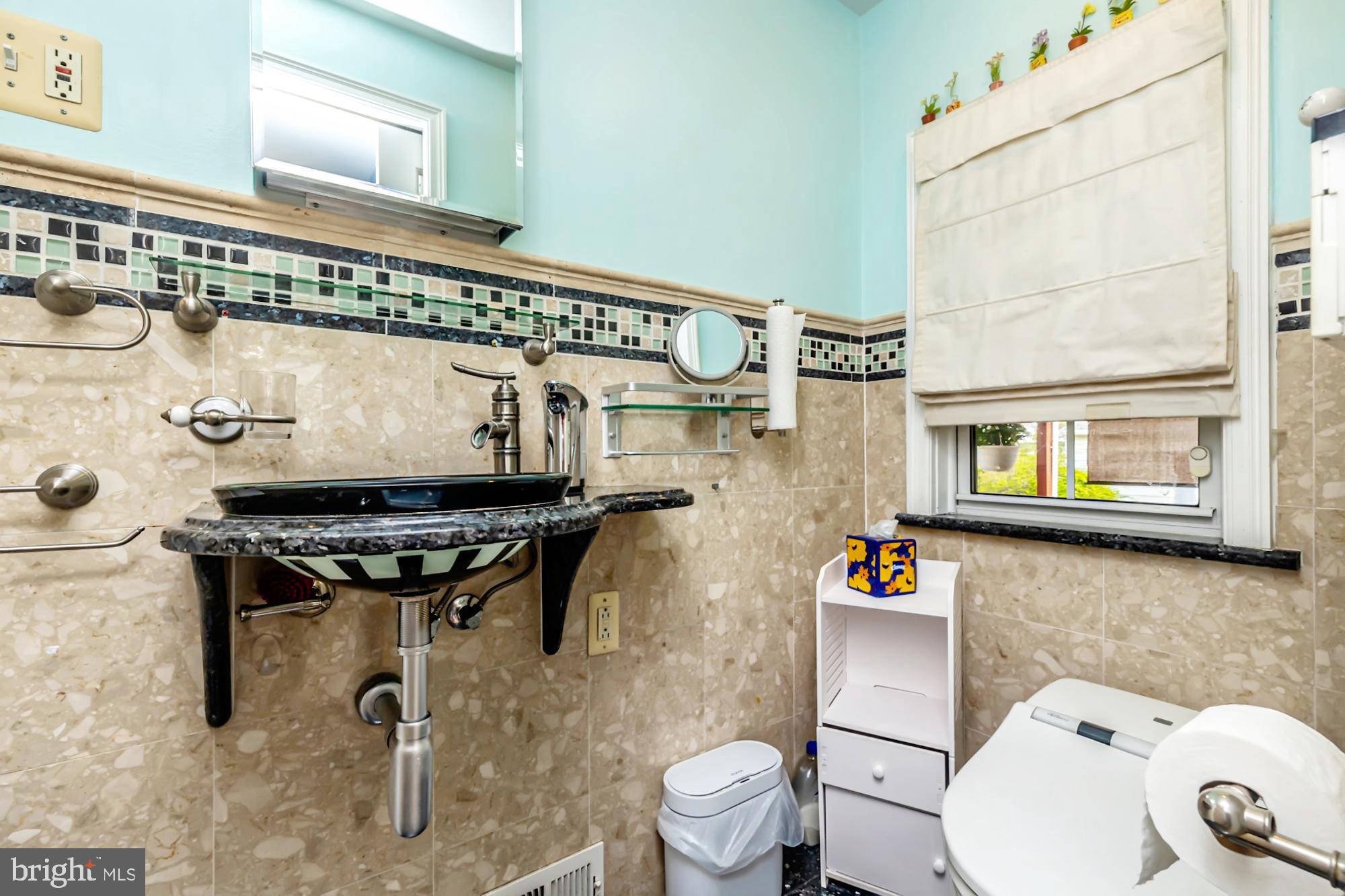 320 Prospect Road Springfield, PA 19064 - Photo 26 of 78 a bathroom with a sink a toilet and a mirror