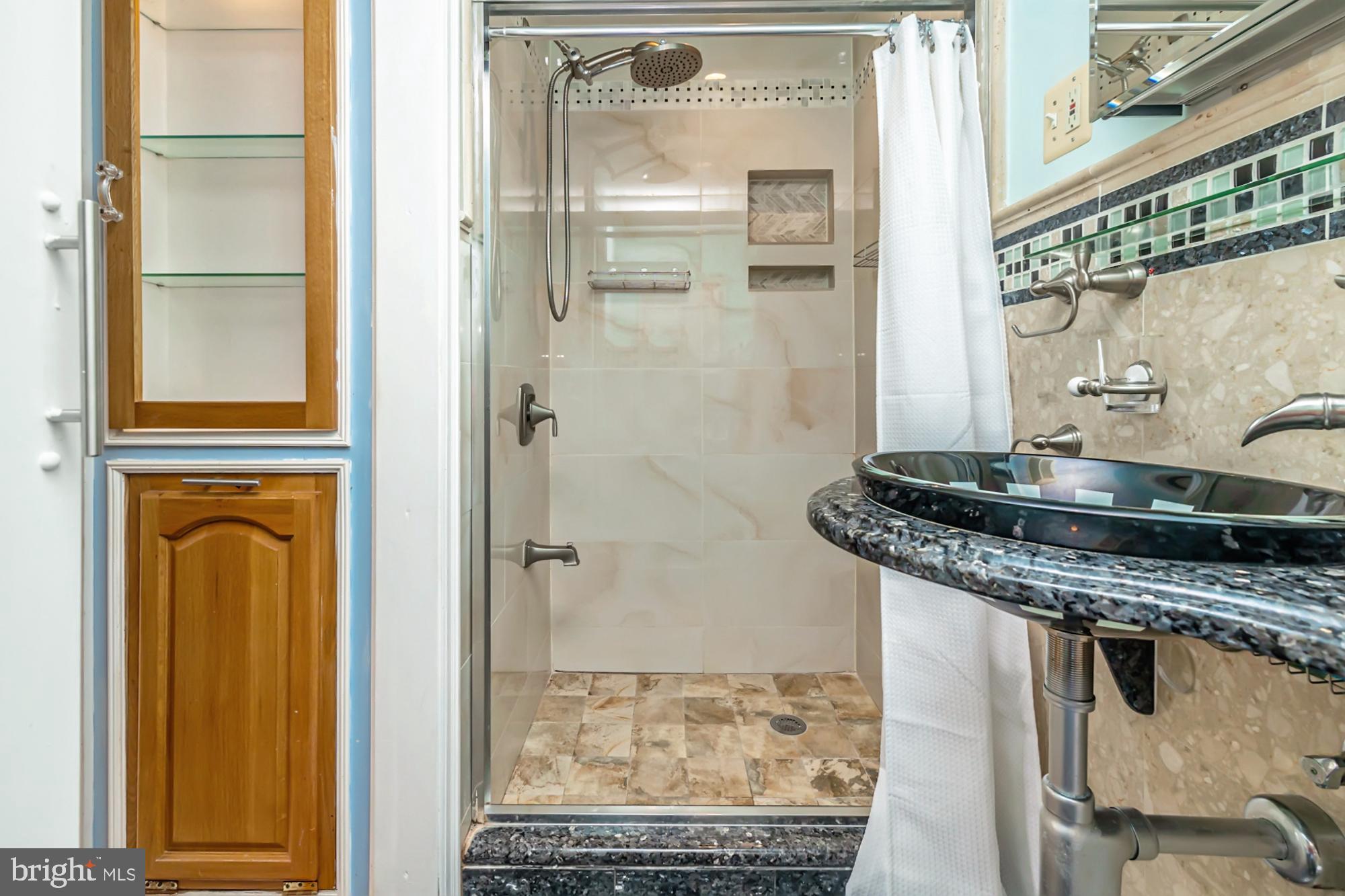 320 Prospect Road Springfield, PA 19064 - Photo 27 of 78 a bathroom with a granite countertop shower a mirror and a sink