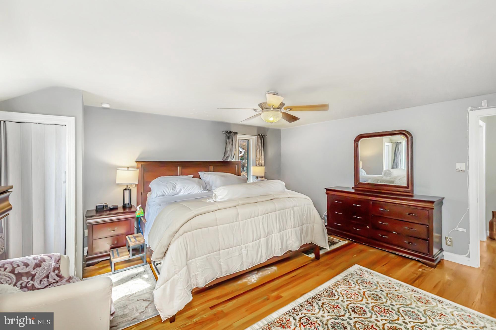320 Prospect Road Springfield, PA 19064 - Photo 30 of 78 a bedroom with a bed and a lamp on dresser