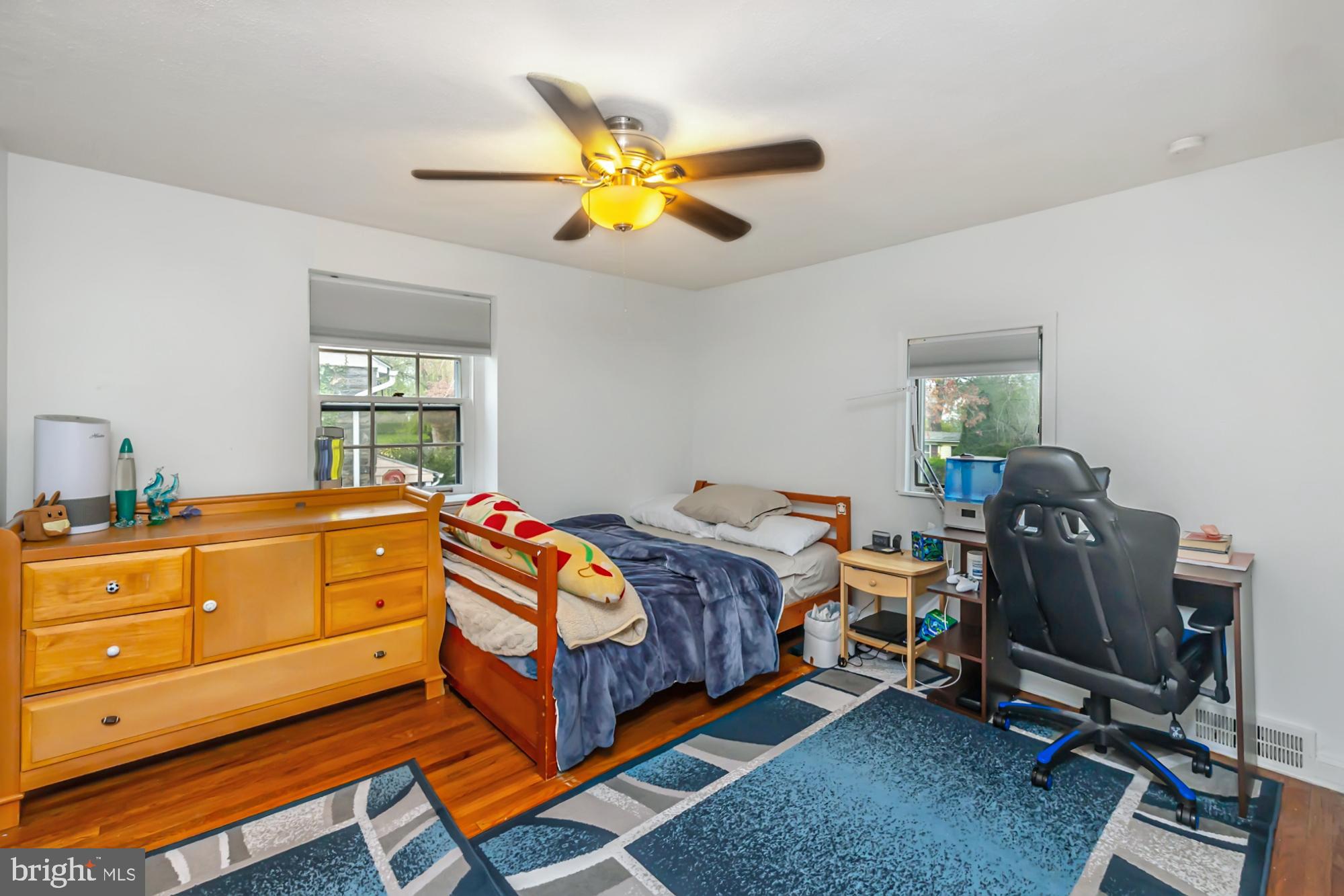 320 Prospect Road Springfield, PA 19064 - Photo 35 of 78 a bedroom with a bed and a chandelier