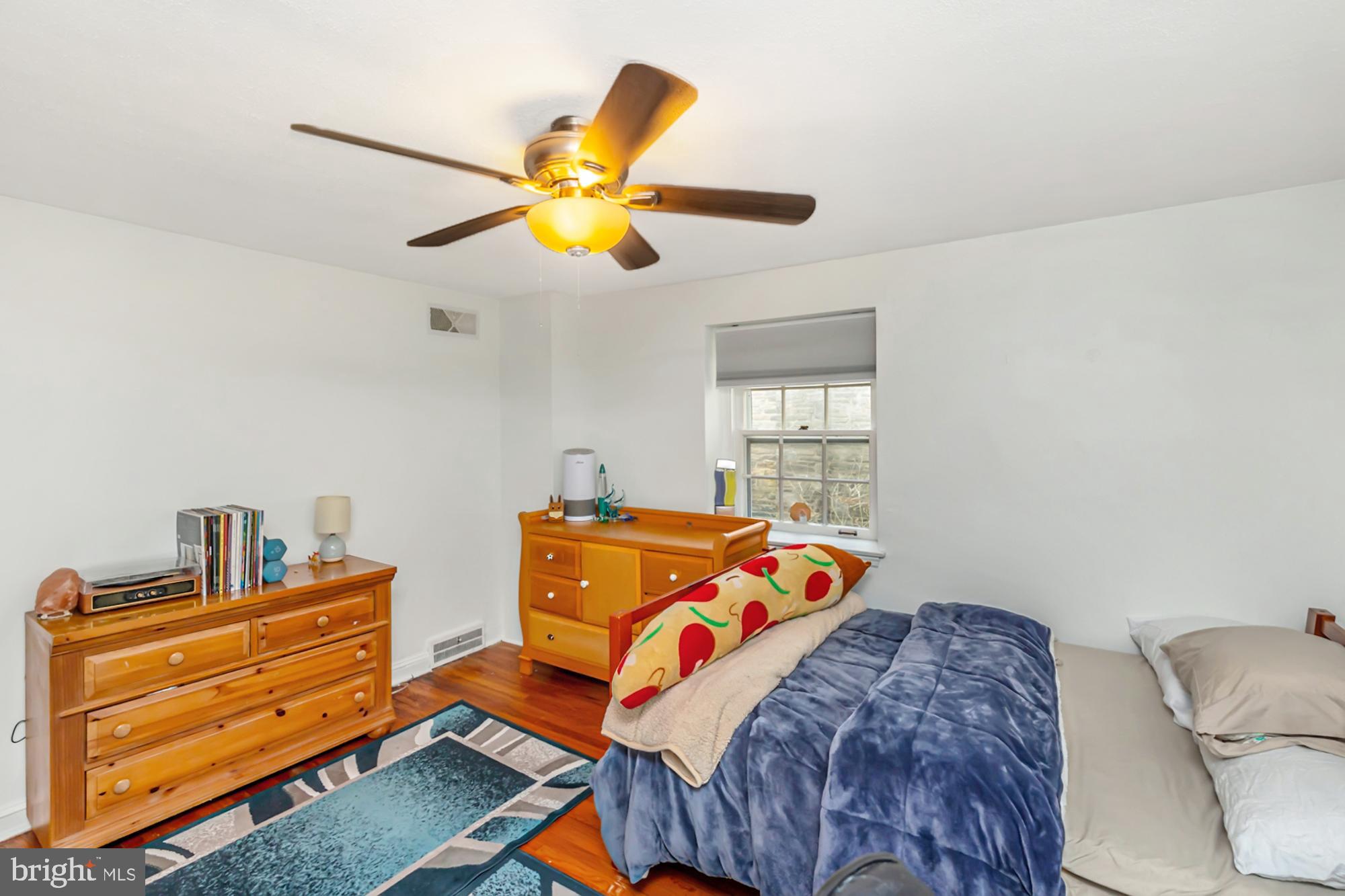 320 Prospect Road Springfield, PA 19064 - Photo 37 of 78 a bedroom with a bed and wooden floor