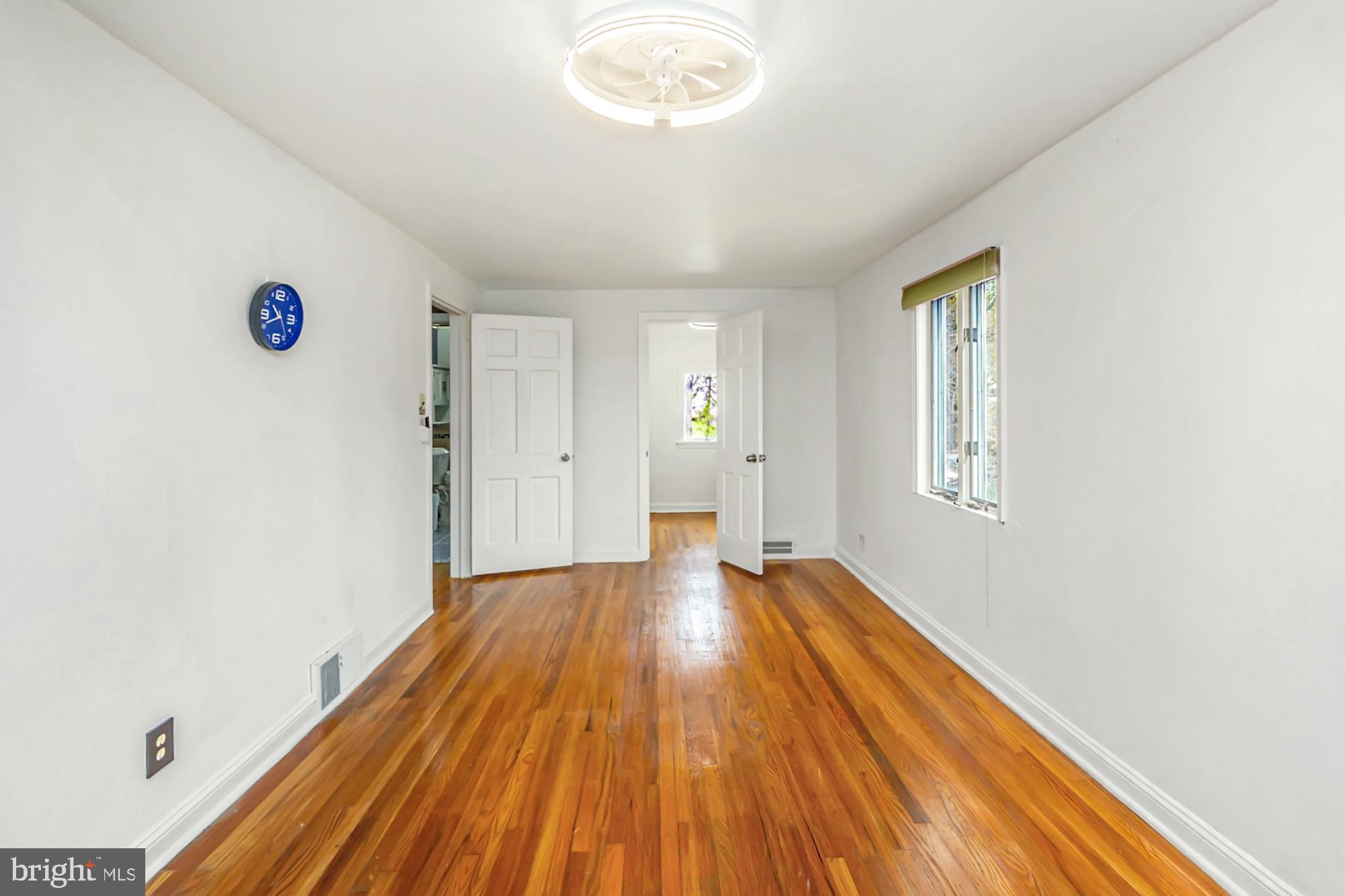 320 Prospect Road Springfield, PA 19064 - Photo 39 of 78 a view of an empty room with wooden floor and a window
