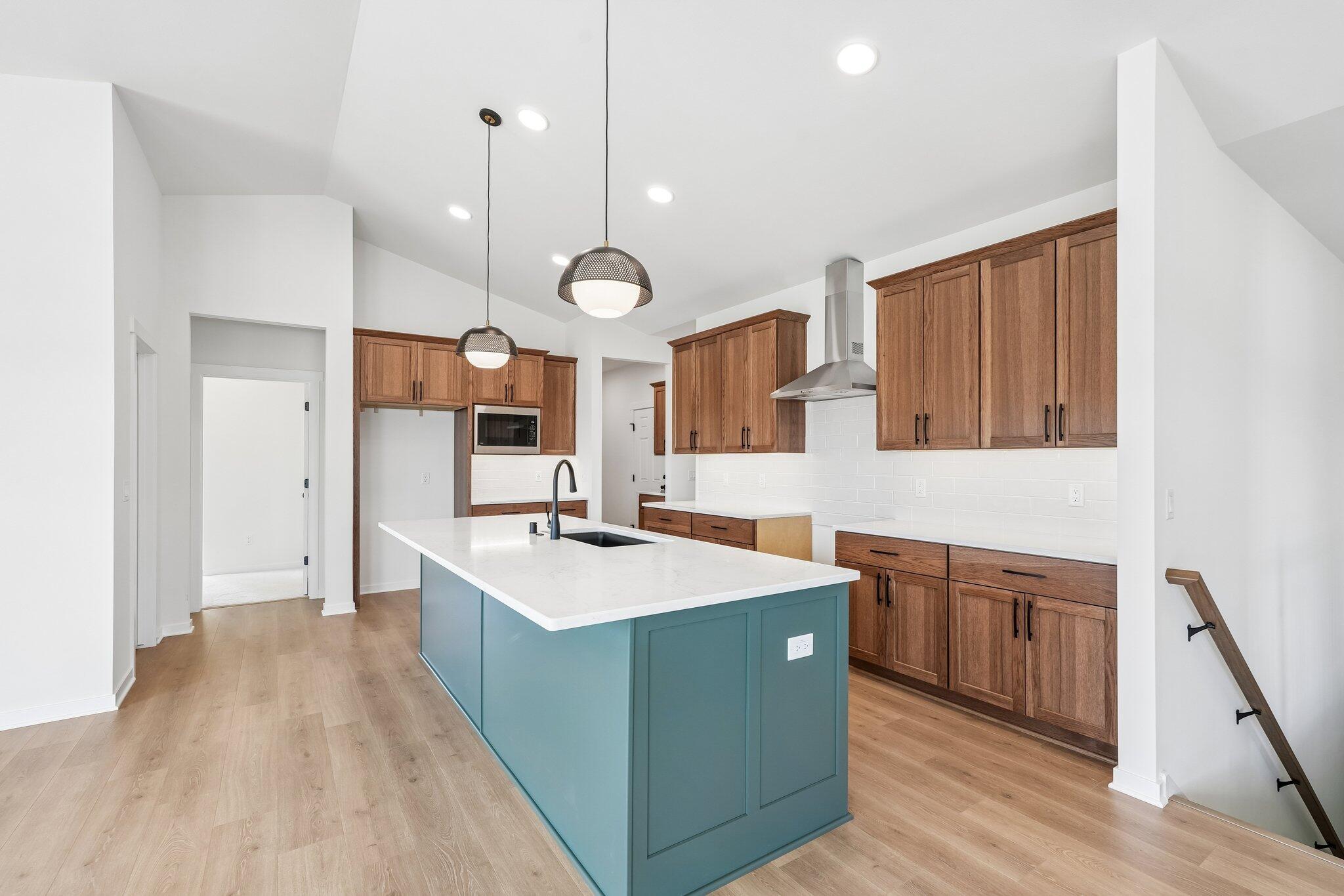 438 Sandstone Street Slinger, WI 53086 - Photo 10 of 29 Kitchen w/ Stained Cabs & Painted Island