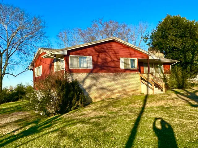a backyard of a house with yard and outdoor seating