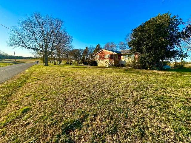 a big house with swimming pool in front of it