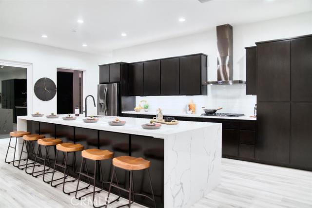 20362 Plaina Road Apple Valley, CA 92307 - Photo 2 of 29 a kitchen with stainless steel appliances kitchen island granite countertop a sink and cabinets