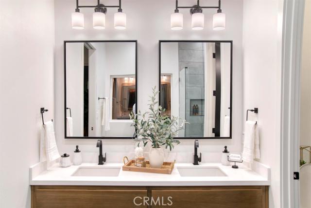 20362 Plaina Road Apple Valley, CA 92307 - Photo 21 of 29 a bathroom with double vanity sinks and a mirror