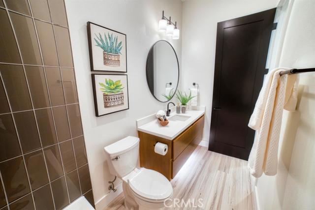 20362 Plaina Road Apple Valley, CA 92307 - Photo 22 of 29 a bathroom with a sink toilet and a mirror