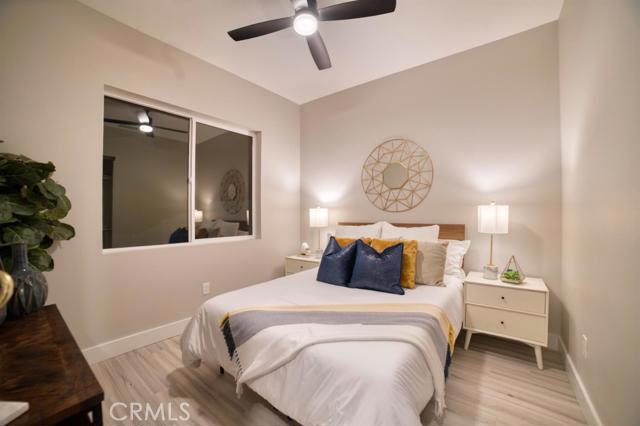 20362 Plaina Road Apple Valley, CA 92307 - Photo 27 of 29 a bedroom with a bed and a chandelier