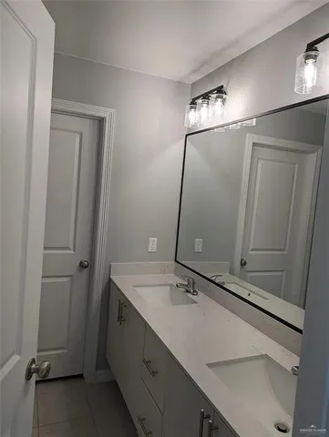 a bathroom with a sink and mirror