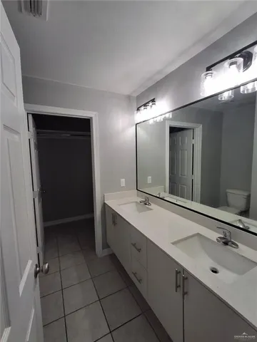 a bathroom with a double vanity sink and mirror