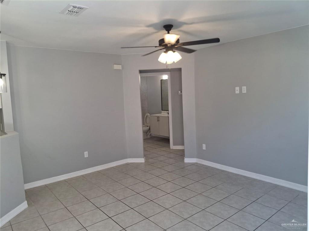 2104 Multi National, Unit C Harlingen, TX 78550 - Photo 14 of 14 a view of an empty room and chandelier fan