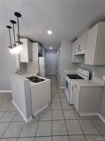 a kitchen with a sink a stove and refrigerator