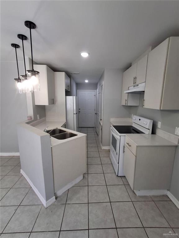 2104 Multi National, Unit C Harlingen, TX 78550 - Photo 4 of 14 a kitchen with a sink a stove and refrigerator