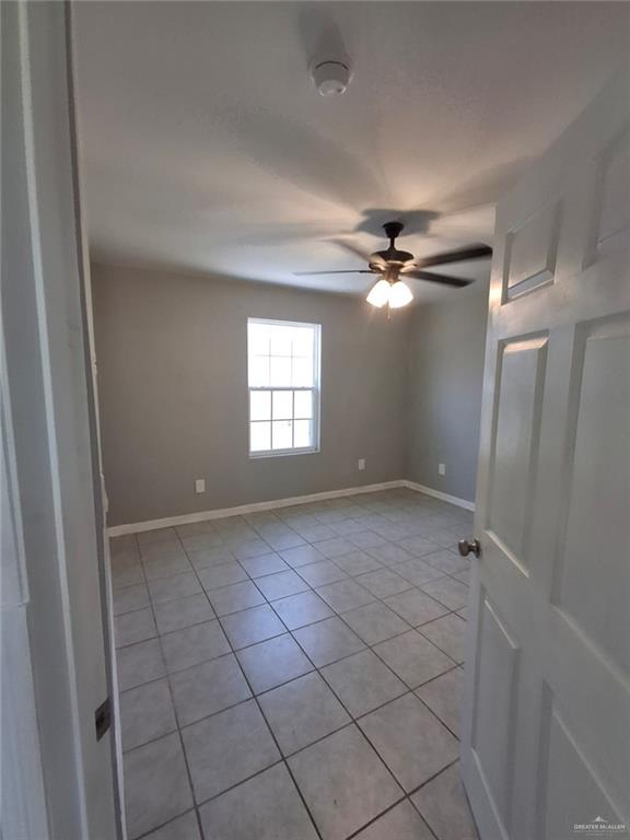 2104 Multi National, Unit C Harlingen, TX 78550 - Photo 8 of 14 a view of a livingroom with a ceiling fan and window