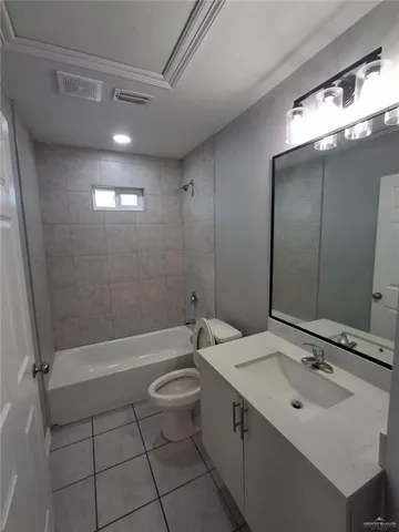a bathroom with a sink a toilet a mirror and shower