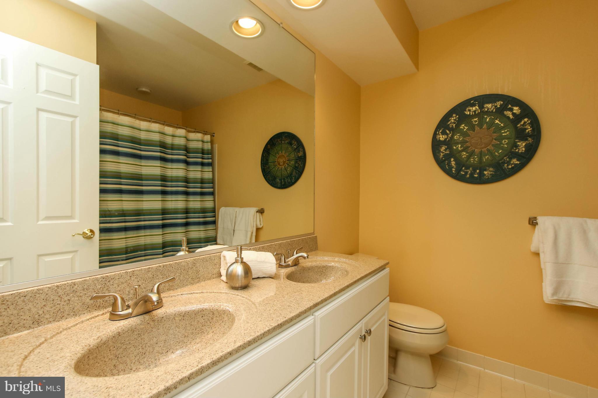 309 Saddle Ridge Road Annapolis, MD 21403 - Photo 17 of 29 a bathroom with a granite countertop sink and a mirror