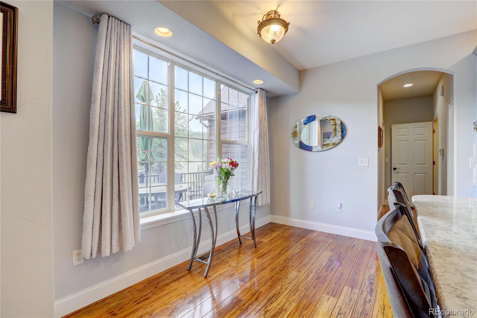 634 Foxtail Circle Black Hawk, CO 80422 - Photo 12 of 40 a view of a livingroom with furniture wooden floor and a large window
