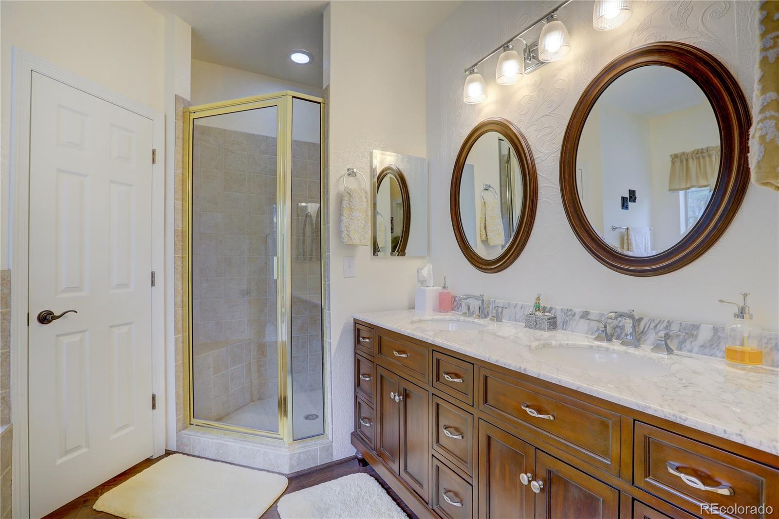 634 Foxtail Circle Black Hawk, CO 80422 - Photo 14 of 40 a bathroom with a granite countertop double vanity sink and a mirror
