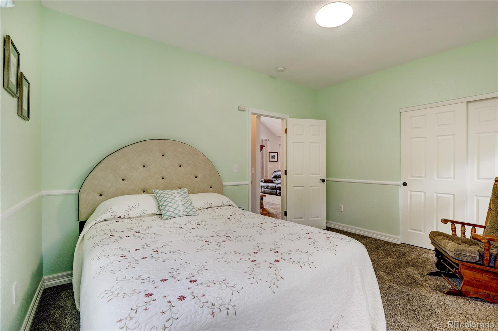 634 Foxtail Circle Black Hawk, CO 80422 - Photo 17 of 40 a bedroom with a bed and a dresser in it