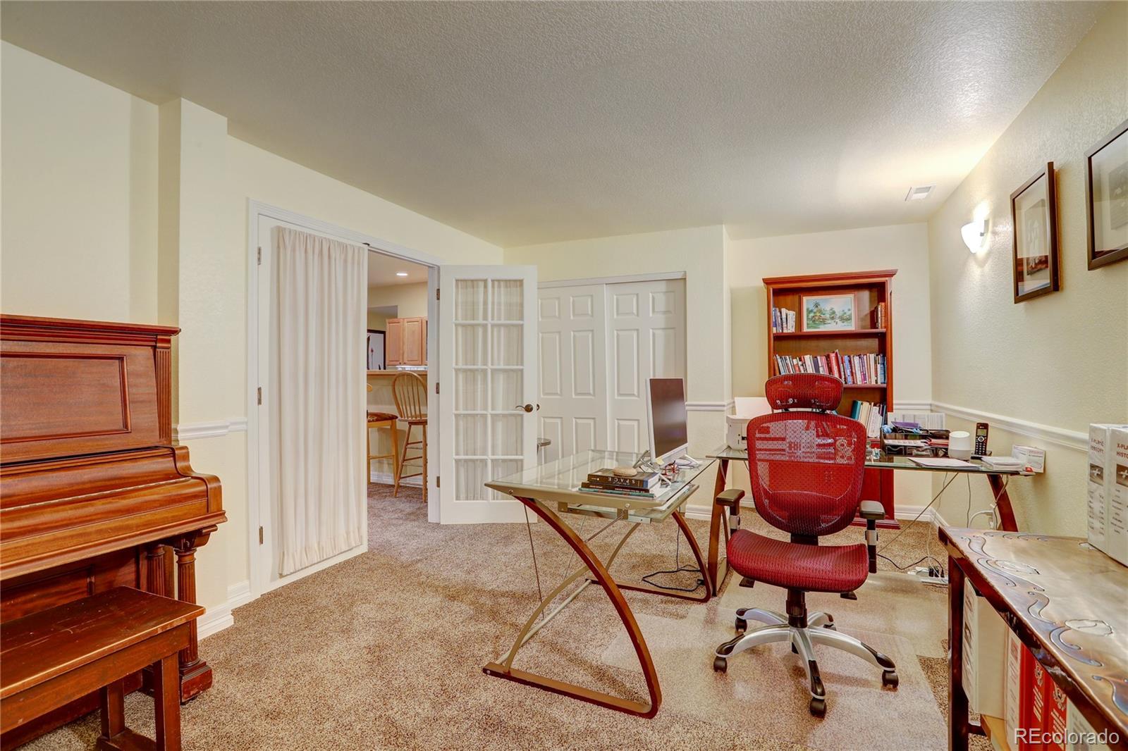 634 Foxtail Circle Black Hawk, CO 80422 - Photo 27 of 40 a workspace room with furniture and wooden floor
