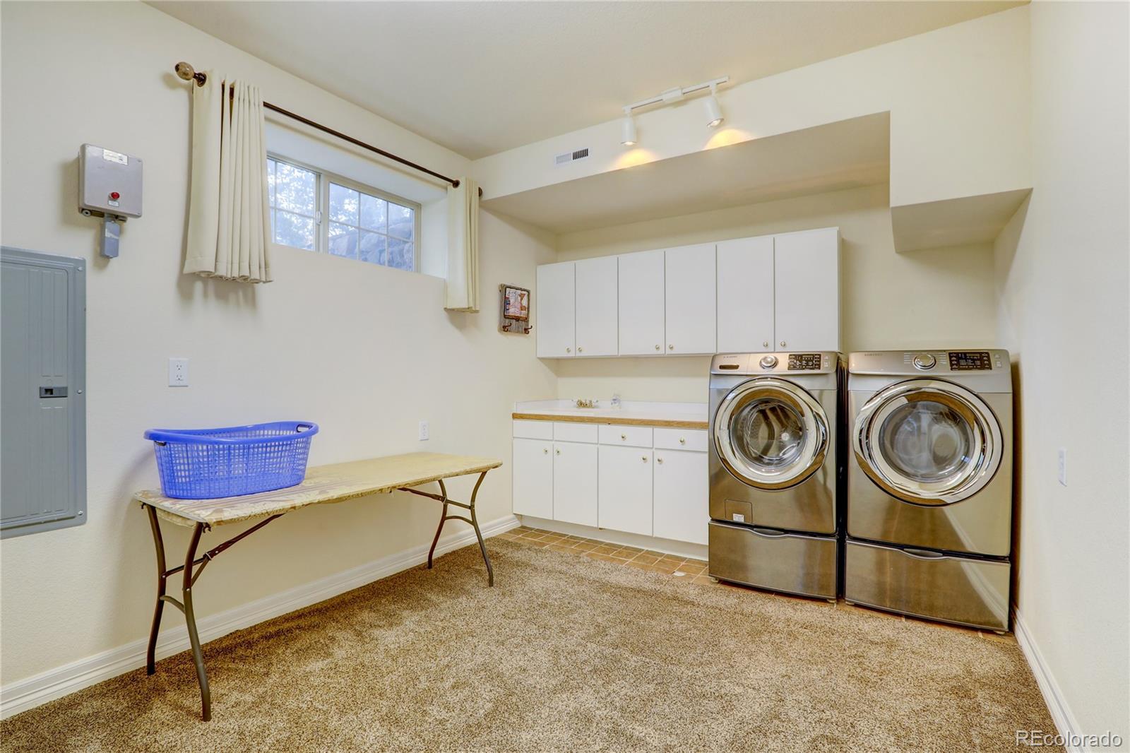 634 Foxtail Circle Black Hawk, CO 80422 - Photo 31 of 40 a utility room with dryer washer and a view of living room