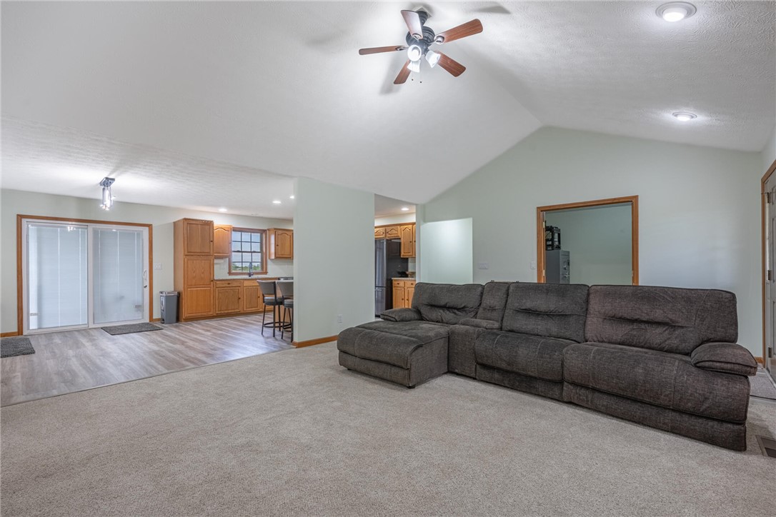2645 Vance Road St. Paris, OH 43072 - Photo 6 of 35 This inviting great room showcases both carpet and wood-look flooring, leading into an open-concept kitchen with ample cabinetry.