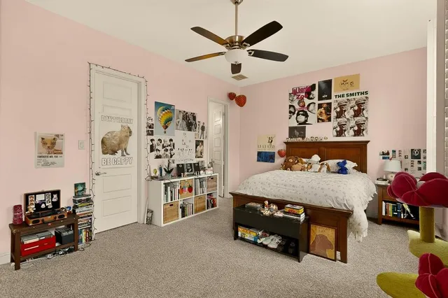 a bedroom with a bed and a book shelf