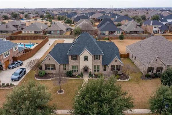 an aerial view of a house with a yard