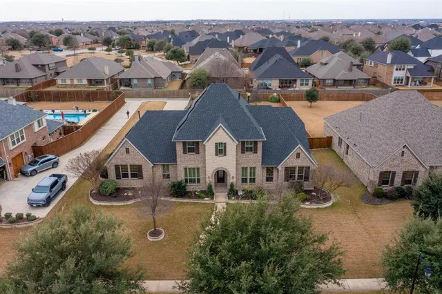 an aerial view of a house with a yard