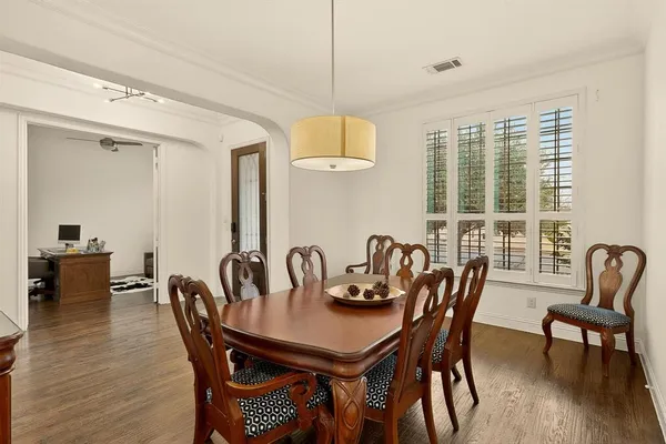 a view of a a dining room with furniture window and wooden floor