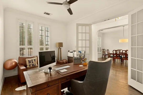 a view of a workspace with furniture and a window