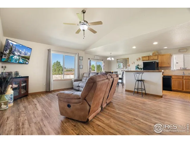 a living room with furniture and kitchen view