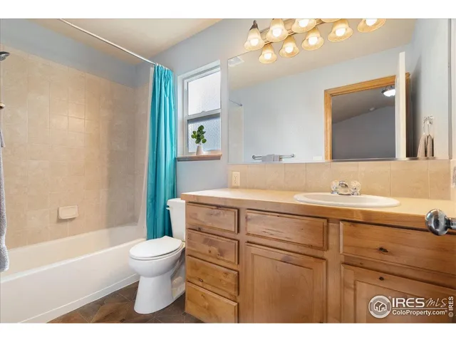 a bathroom with a sink a toilet and bathtub