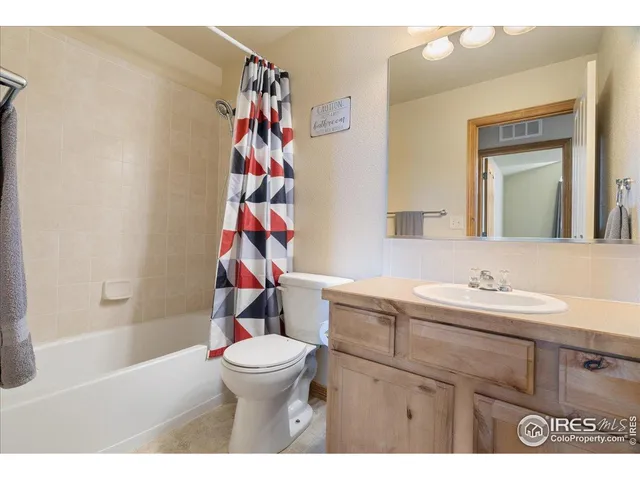 a bathroom with a sink a toilet and a shower