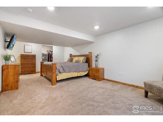 a spacious bedroom with a bed and a cabinets