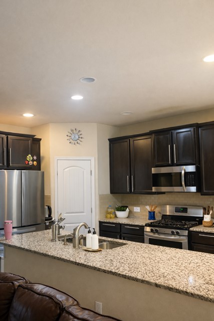 11613 Reading Court Austin, TX 78717 - Photo 6 of 16 a kitchen with stainless steel appliances granite countertop a sink stove and microwave