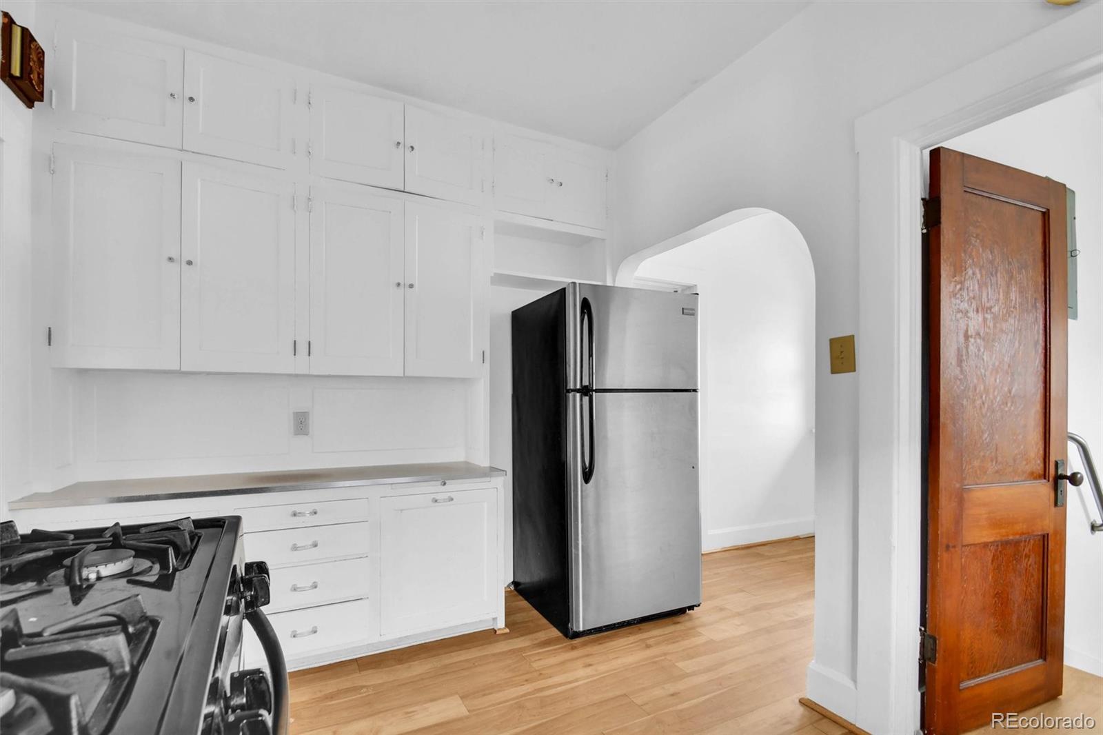 3159 West 36th Avenue Denver, CO 80211 - Photo 13 of 33 a kitchen with a refrigerator and a stove