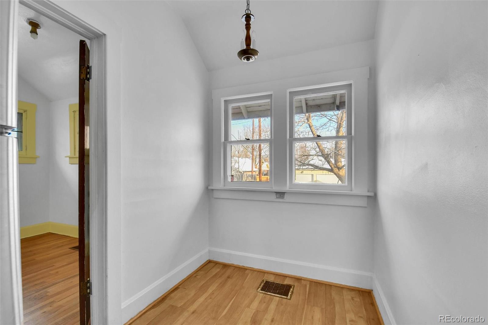 3159 West 36th Avenue Denver, CO 80211 - Photo 17 of 33 wooden floor in an empty room with a window
