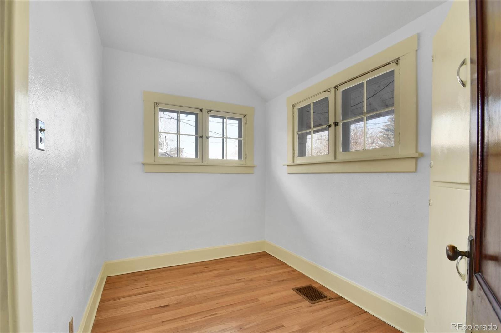 3159 West 36th Avenue Denver, CO 80211 - Photo 18 of 33 a view of an empty room with wooden floor and a window