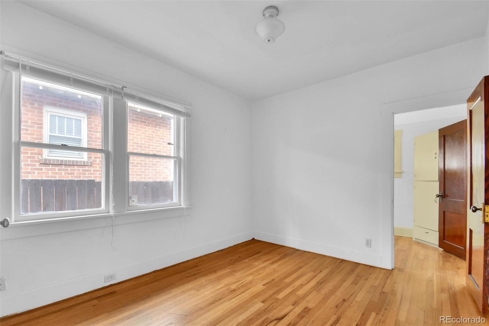 3159 West 36th Avenue Denver, CO 80211 - Photo 21 of 33 a view of empty room with wooden floor and fan