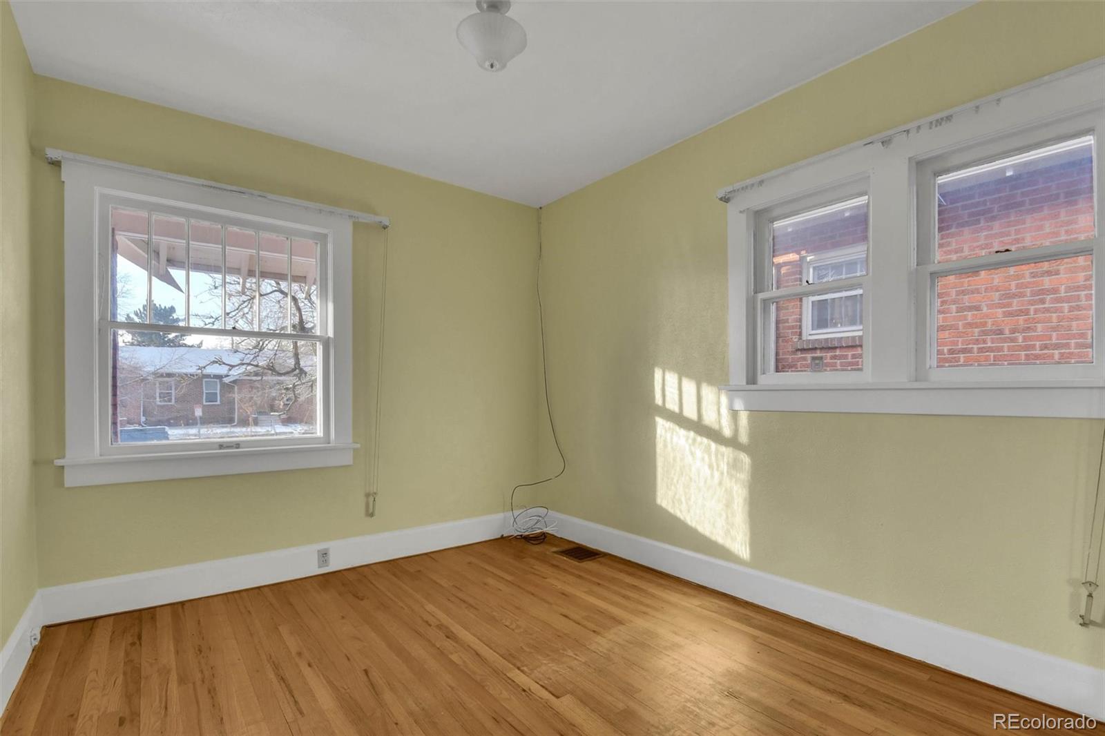 3159 West 36th Avenue Denver, CO 80211 - Photo 22 of 33 a view of an empty room with wooden floor and a window