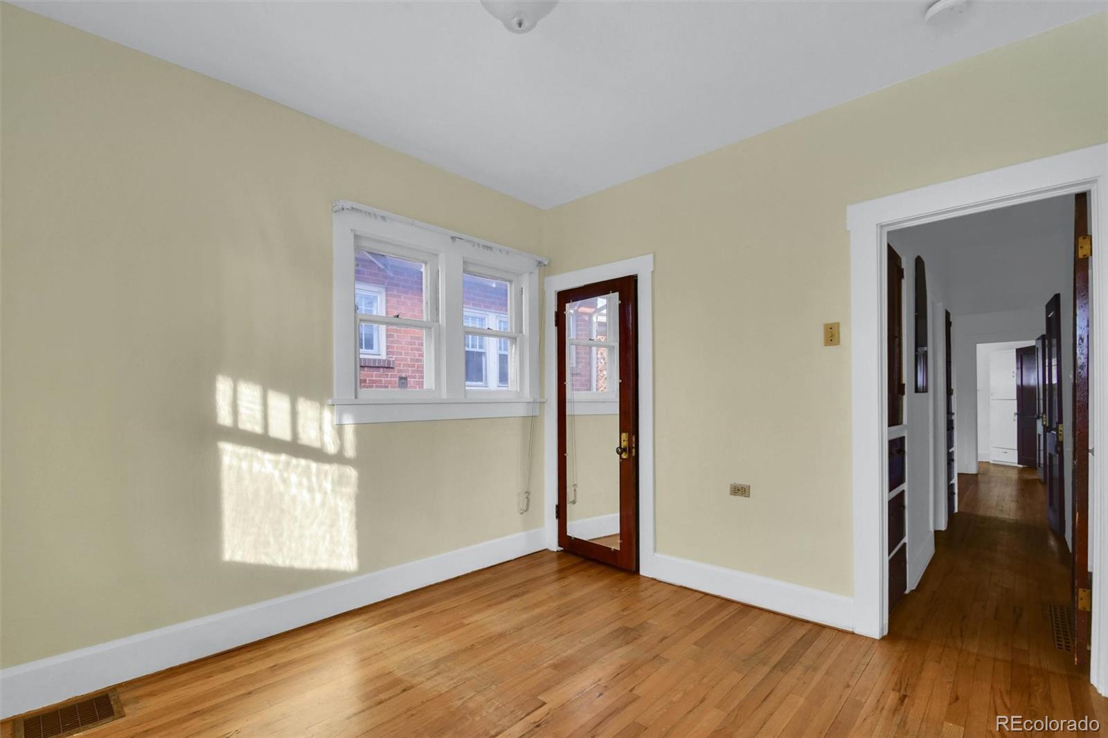 3159 West 36th Avenue Denver, CO 80211 - Photo 23 of 33 a view of an empty room with window and wooden floor