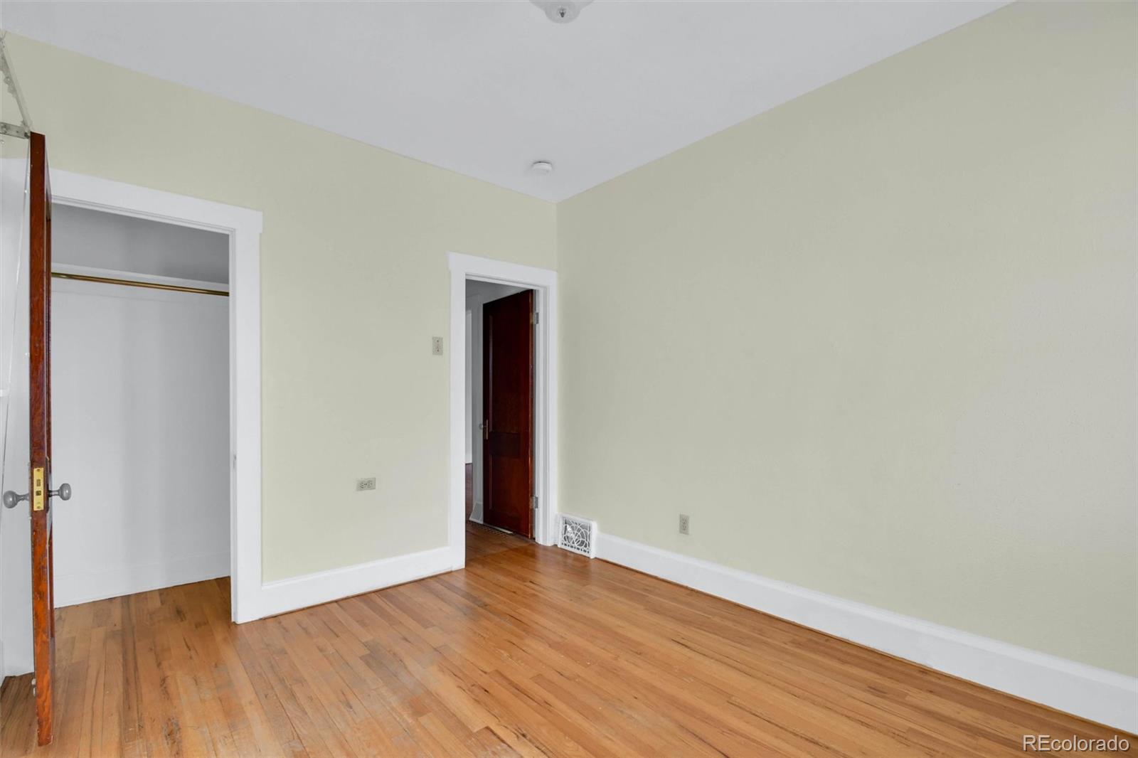 3159 West 36th Avenue Denver, CO 80211 - Photo 24 of 33 a view of an empty room with wooden floor and a window