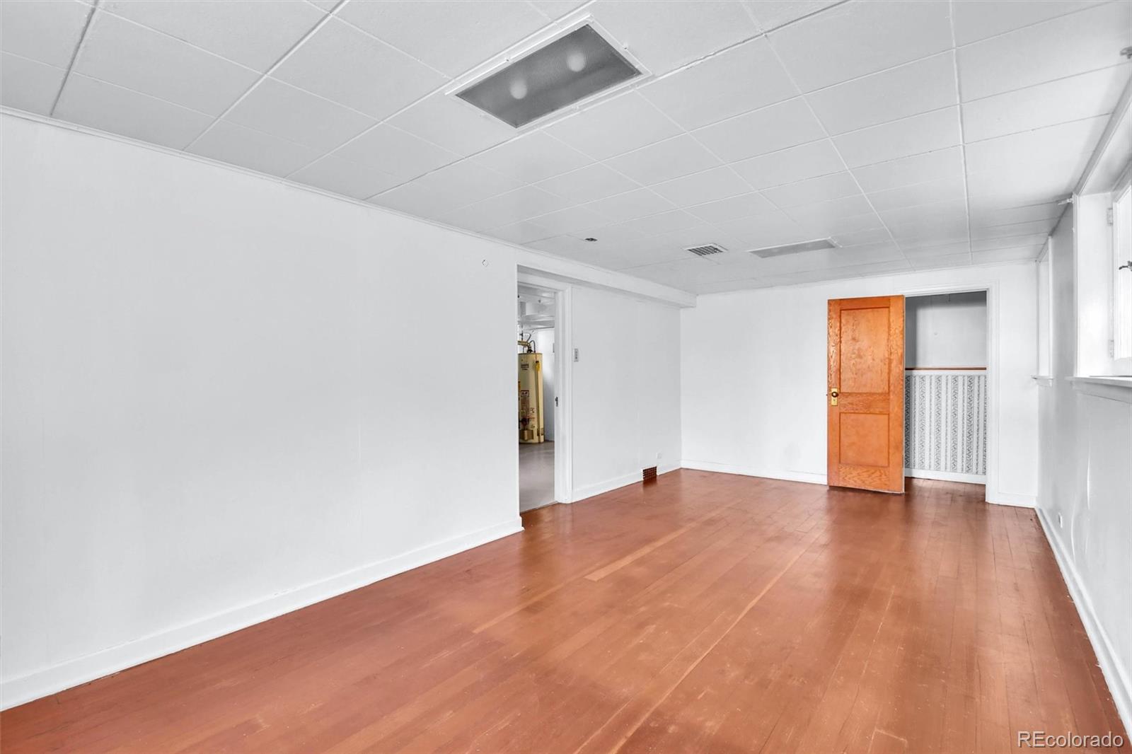 3159 West 36th Avenue Denver, CO 80211 - Photo 26 of 33 a view of an empty room with wooden floor and a window